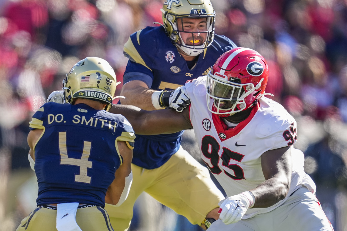 Nov 27, 2021; Atlanta, Georgia, USA; Georgia Bulldogs defensive lineman Devonte Wyatt (95) tries to tackle Georgia Tech Yellow Jackets running back Dontae Smith (4) during the first half at Bobby Dodd Stadium. Mandatory Credit: Dale Zanine-USA TODAY Sports